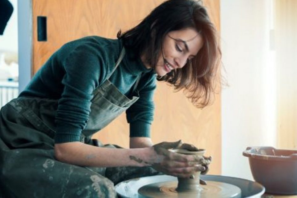 Young woman artist in ceramic workshop
